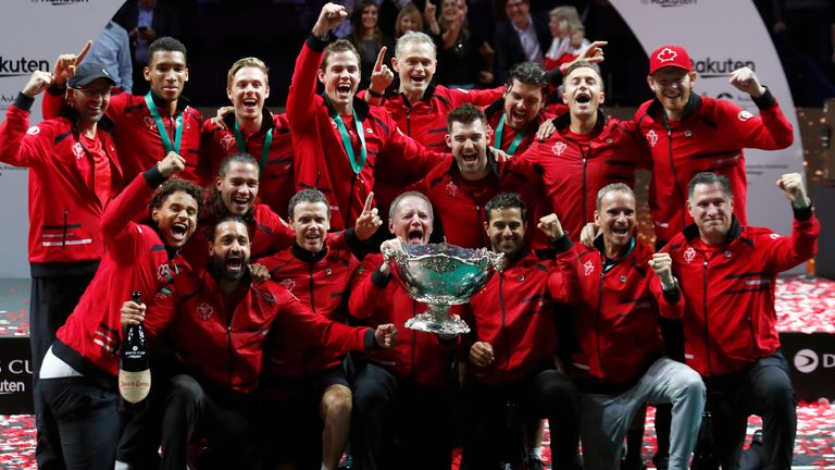 Team Canada celebrate with the trophy after winning the Davis Cup tennis final in Malaga (AP Photo/Joan Monfort)