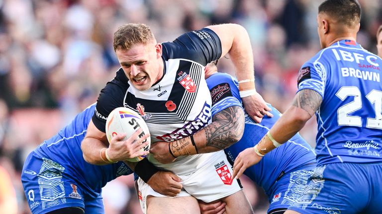 Picture by Will Palmer/SWpix.com - 12/11/2022 - Rugby League - Rugby League World Cup 2021 - Semi Final - England v Samoa - Emirates Stadium, London, England - Tom Burgess of England is tackled by Jaydn Su...a, Brian To...o and Royce Hunt of Samoa