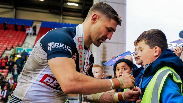 Tommy Makinson celebrates with England's fans after his five-try haul
