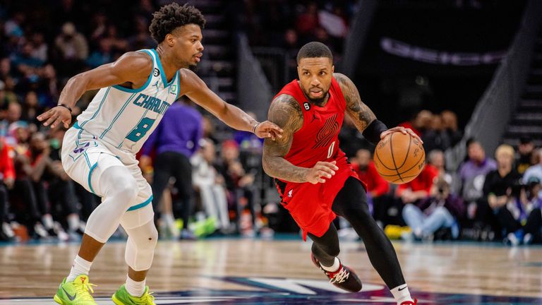 Charlotte Hornets guard Dennis Smith Jr. (8) guards Portland Trail Blazers guard Damian Lillard (0) during the second half of an NBA basketball game Wednesday, Nov. 9, 2022, in Charlotte, N.C. 