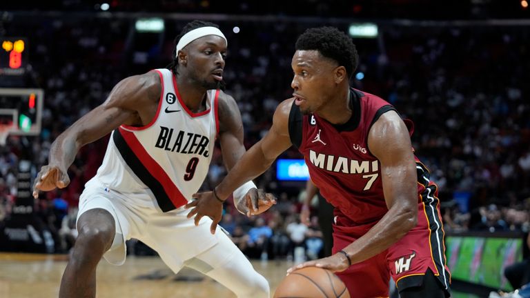 Miami Heat guard Kyle Lowry drives to the basket against Portland Trail Blazers forward Jerami Grant during the second half of an NBA basketball game, Monday, Nov. 7, 2022, in Miami.