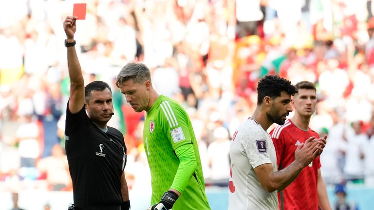 Wayne Hennessey is shown a red card for his challenge on Mehdi Taremi (R)