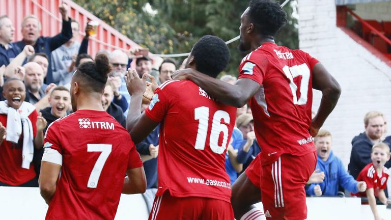 Welling United players celebrate in front of their fans at Park View Road