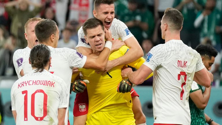 Wojciech Szczesny is mobbed by his team-mates after saving Al-Dawsari's penalty