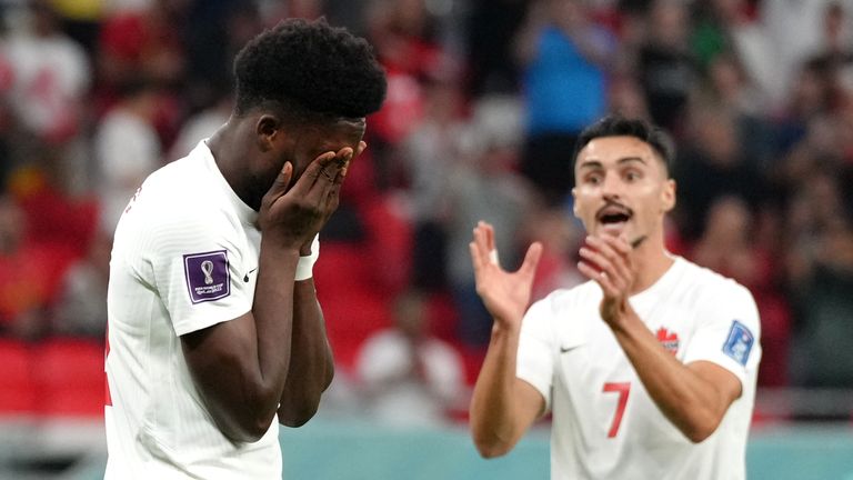 Alphonso Davies holds his head in his hands after seeing his first-half penalty saved