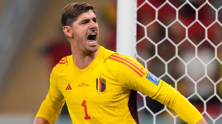 Thibaut Courtois celebrates after saving Alphonso Davies' penalty