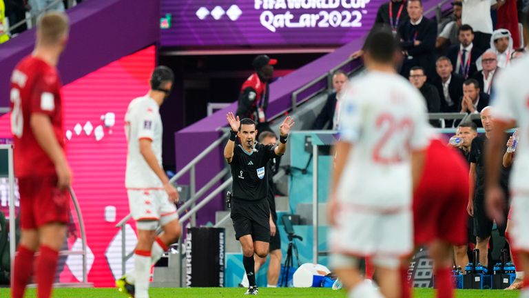 Referee Cesar Arturo Ramos gives directions to players during the World Cup group D soccer match between Denmark and Tunisia, at the Education City Stadium in Al Rayyan , Qatar, Tuesday, Nov. 22, 2022. (AP Photo/Petr David Josek)