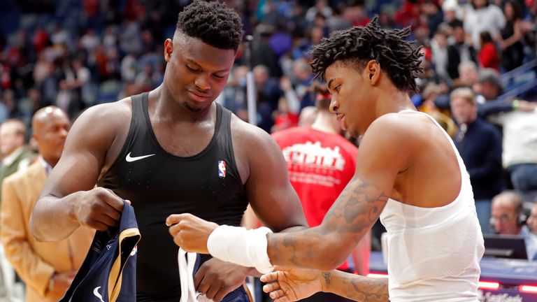 Zion Williamson, left, and Ja Morant, right, swap shirts after facing each other on court in February 2020