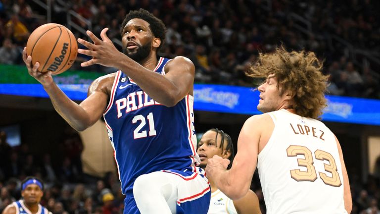 Philadelphia 76ers center Joel Embiid (21) drives against Cleveland Cavaliers center Robin Lopez (33) during the second half of an NBA basketball game, Wednesday, Nov. 30, 2022, in Cleveland.v