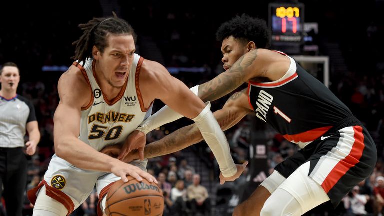 Denver Nuggets forward Aaron Gordon, left, drives to the basket on Portland Trail Blazers guard Anfernee Simons, right, during the first half of an NBA basketball game in Portland, Ore., Thursday, Dec. 8, 2022.