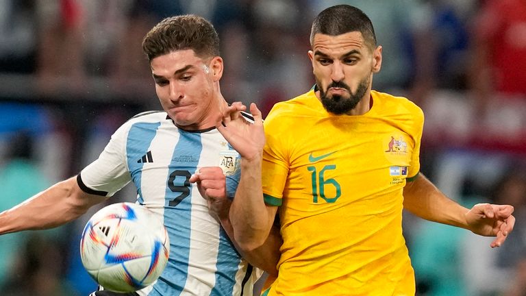 Julian Alvarez goes shoulder to shoulder with Aziz Behich