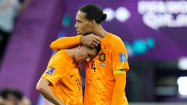 Virgil van Dijk consoles a team-mate following Netherlands' World Cup exit