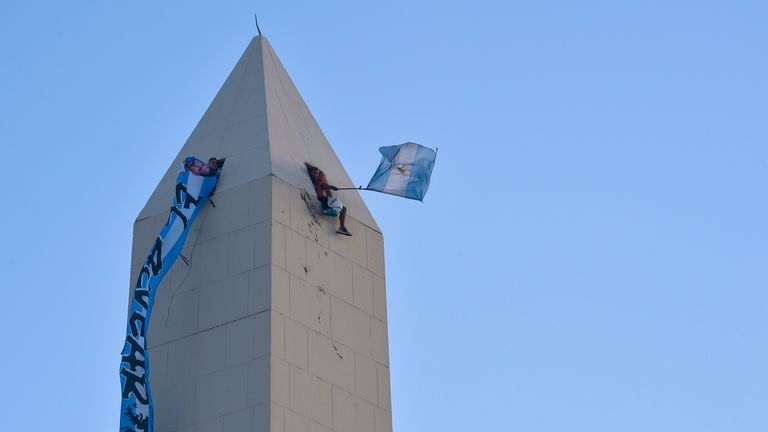 Fans even went all the way to the top of the Obelisk monument to catch a glimpse of the Argentina bus parade