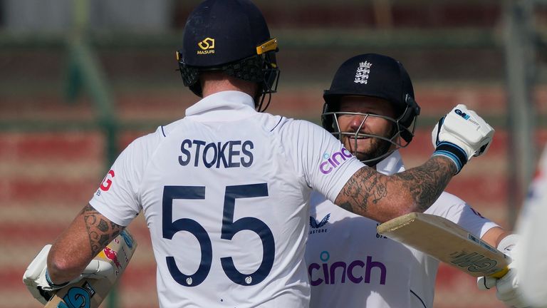 England's Ben Duckett, right, celebrates with teammate Ben Stokes after winning the third test cricket match against Pakistan, in Karachi, Pakistan, Tuesday, Dec. 20, 2022. (AP Photo/Fareed Khan)