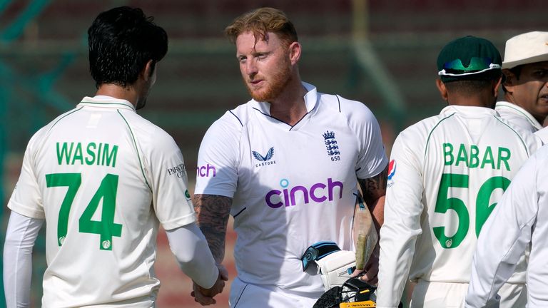 England's skipper Ben Stokes, center, shakes hand with Pakistani players after winning the third test cricket match against Pakistan, in Karachi, Pakistan, Tuesday, Dec. 20, 2022. (AP Photo/Fareed Khan)
