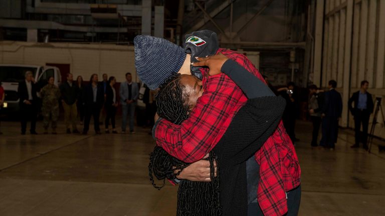 This photo provided by the U.S. Army shows WNBA star Brittney Griner, right, being greeted by wife Cherelle.
