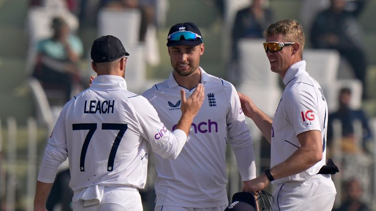 England&#39;s Will Jacks, center, who took six wickets in first inning, is congratulated by teammates during the fourth day of the first test cricket match between Pakistan and England, in Rawalpindi, Pakistan, Sunday, Dec. 4, 2022. (AP Photo/Anjum Naveed)
