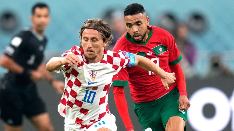 Luka Modric is tracked by Youssef En-Nesyri