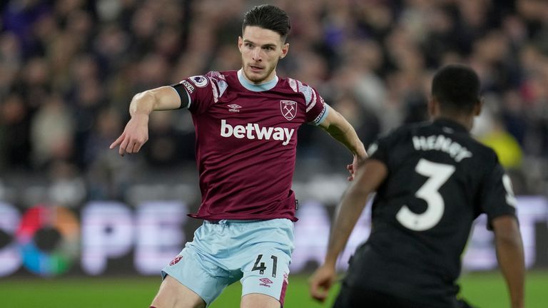 West Ham's Declan Rice (left) dribbles past Brentford's Rico Henry during the English Premier League football match between West Ham United and Brentford at the London Stadium in London, Friday 30 December 2022 I'm trying  (AP Photo/Kin Cheung)