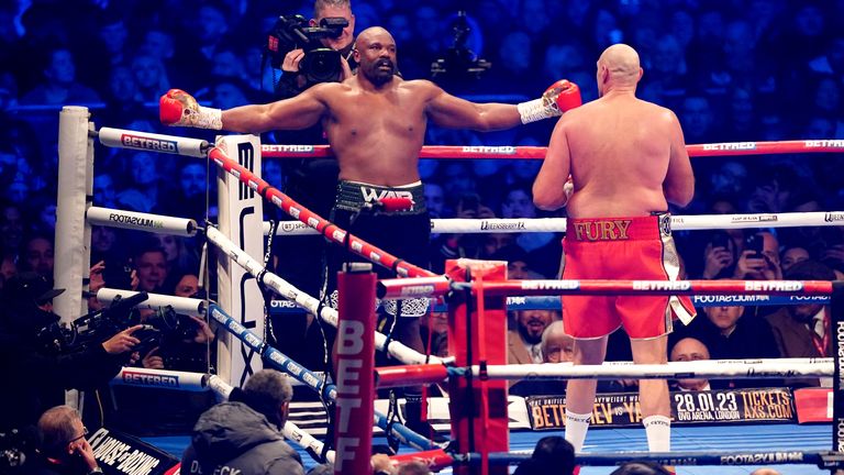 Derek Chisora holds out his arms against Tyson Fury 