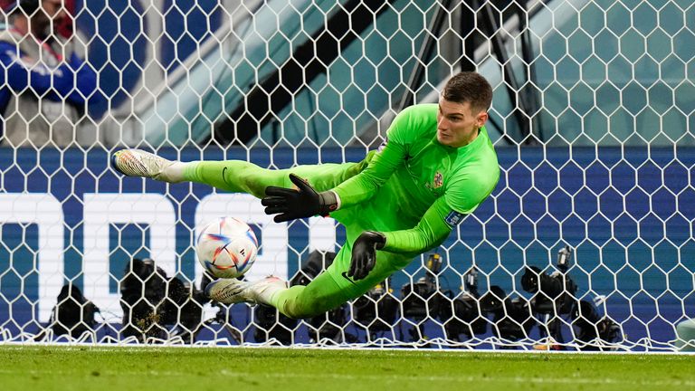 's goalkeeper Dominik Livakovic makes a save during the penalty shootout against Japan