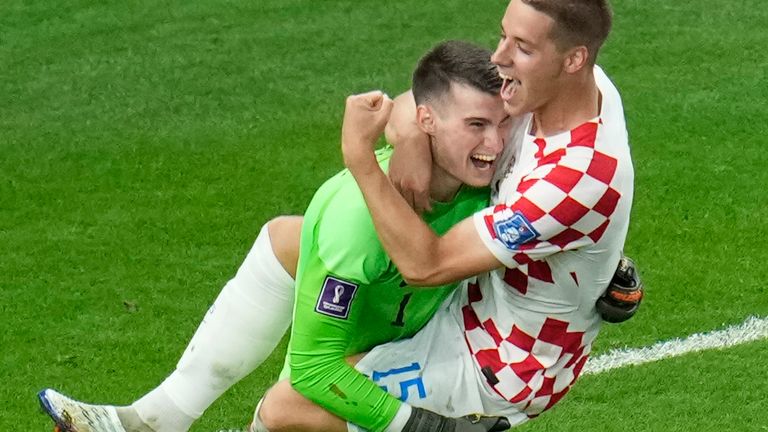 Croatia&#39;s goalkeeper Dominik Livakovic celebrates with team-mate Mario Pasalic at full time