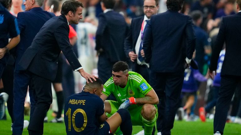 France's President Emmanuel Macron and Argentina goalkeeper Emiliano Martinez confort Kylian Mbappe at the end of the World Cup final