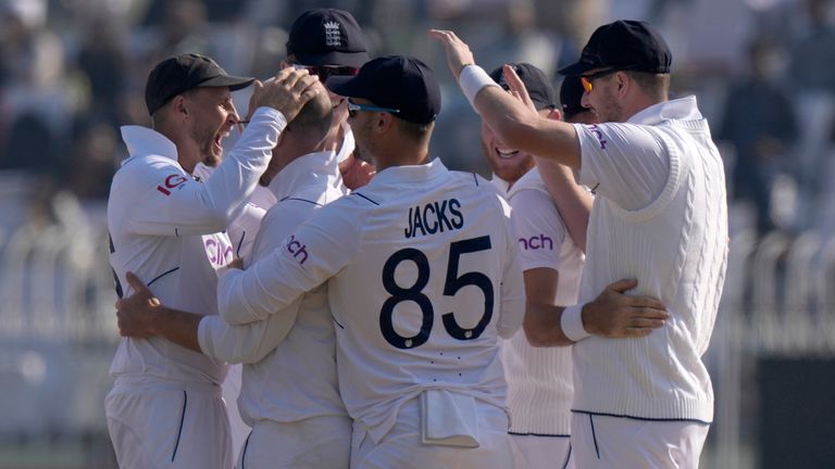 England's Jack Leach, center, celebrates with teammates after taking the wicket of Pakistan's Imam-ul-Haq during the third day of the first test cricket match between Pakistan and England, in Rawalpindi, Pakistan, Saturday, Dec. 3, 2022. (AP Photo/Anjum Naveed)