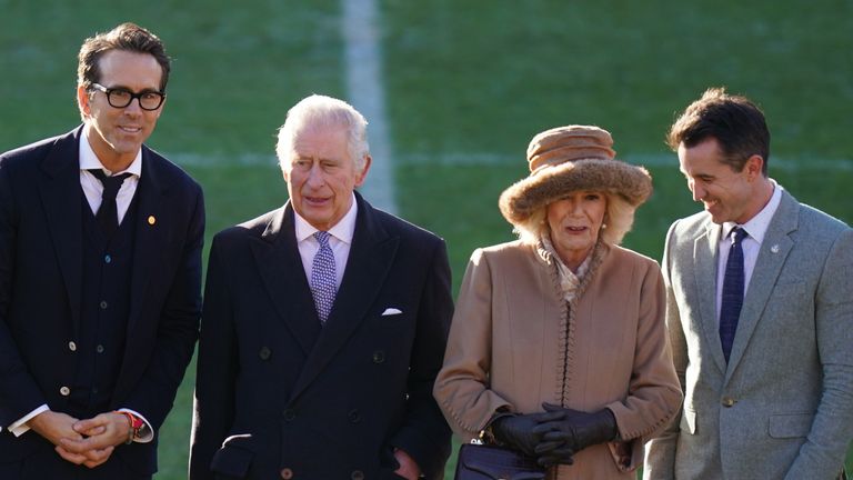 King Charles III and the Queen Consort during their visit to Wrexham Association Football Club&#39;s Racecourse Ground, meeting owners and Hollywood actors, Ryan Reynolds (far left) and Rob McElhenney (far right), and players to learn about the redevelopment of the club, as part of their visit to Wrexham