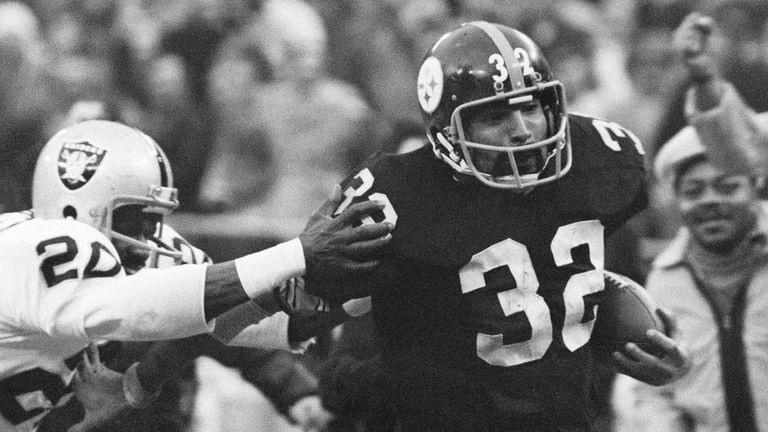 FILE - Pittsburgh Steelers' Franco Harris (32) eludes a tackle by Oakland Raiders' Jimmy Warren as he runs 42-yards for a touchdown after catching a deflected pass during an AFC Divisional NFL football playoff game in Pittsburgh, Dec. 23, 1972. Harris' scoop of a deflected pass and subsequent run for the winning touchdown ... forever known as the "Immaculate Reception" ... has been voted the greatest play in NFL history. On the 50th anniversary of the "Immaculate Reception" ... Friday, Dec. 23, 2022 ... Pittsburghers recall how it boosted morale during the collapse of the steel industry and has served as a cultural rallying point ever since. (AP Photo/Harry Cabluck, File)