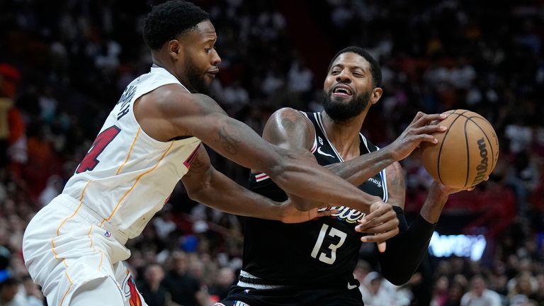 Miami Heat forward Haywood Highsmith, left, attempts to swat the ball away from Los Angeles Clippers forward Paul George (13) during the second half of an NBA basketball game, Thursday, Dec. 8, 2022, in Miami.