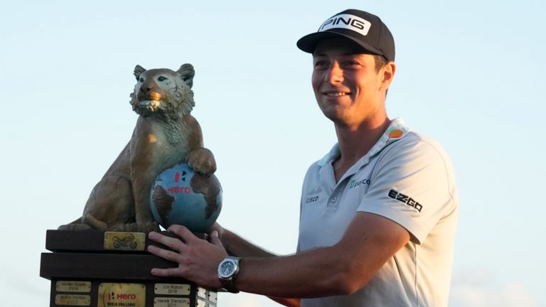 Norway,&#39;s Viktor Hovland, right, holds the trophy after winning the Hero World Challenge PGA Tour at the Albany Golf Club in New Providence, Bahamas, Sunday, Dec. 4, 2022. (AP Photo/Fernando Llano)