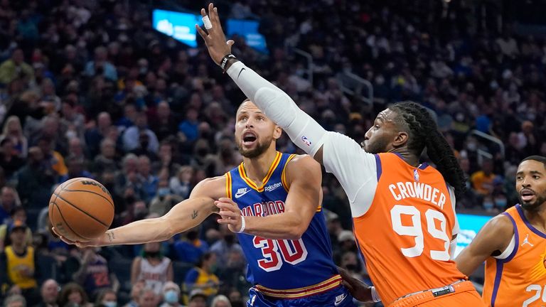 Golden State Warriors guard Stephen Curry (30) shoots against Phoenix Suns forward Jae Crowder (99) during the first half of an NBA basketball game in San Francisco.