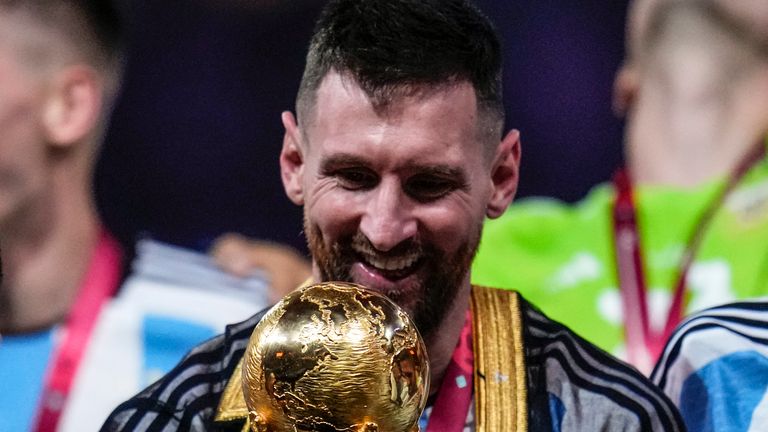 Argentina's Lionel Messi holds the trophy after winning the World Cup final soccer match between Argentina and France at the Lusail Stadium in Lusail, Qatar, Sunday, Dec.18, 2022. (AP Photo/Manu Fernandez)