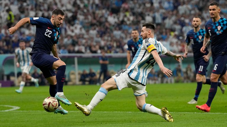 Argentina's Lionel Messi vies for the ball with Croatia's Josip Juranovic