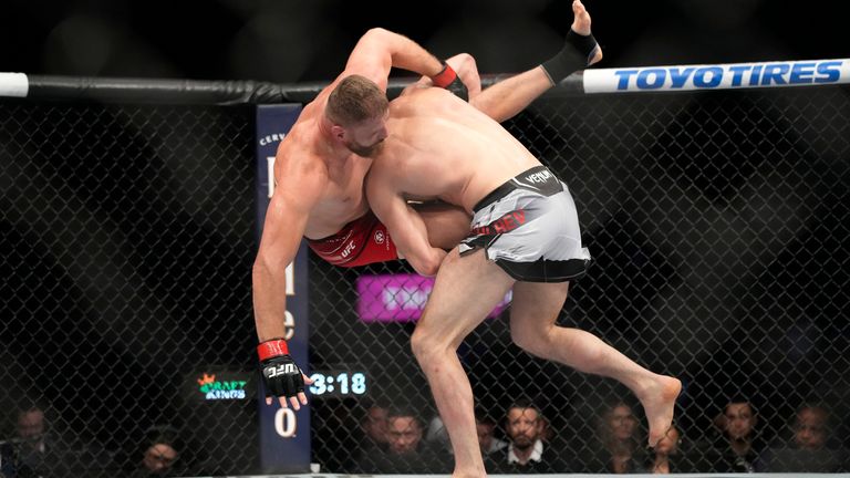 Magomed Ankalaev, right, takes down Jan Blachowicz during a UFC 282 mixed martial arts light heavyweight title bout Saturday, Dec. 10, 2022, in Las Vegas. (AP Photo/John Locher)
