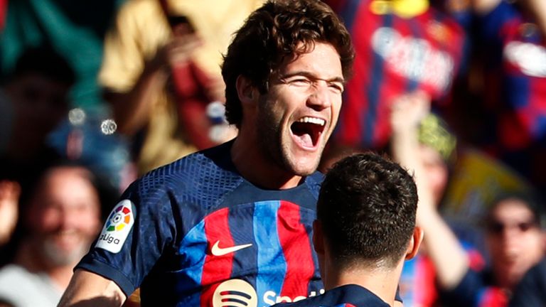 Barcelona&#39;s Marcos Alonso, top left, celebrates with Andreas Christensen after scoring the opening goal during a Spanish La Liga soccer derby match between Barcelona and Espanyol at the Camp Nou stadium in Barcelona, Spain, Saturday, Dec. 31, 2022. (AP Photo/Joan Monfort)