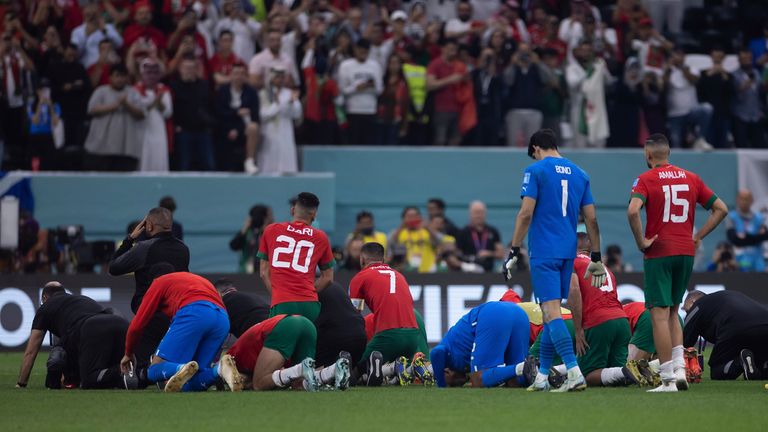 Morocco players are seen kneeling at the end of the match against France