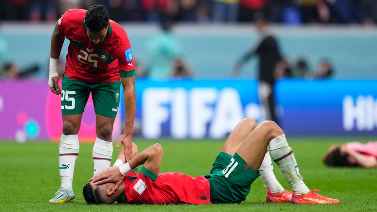 Morocco&#39;s Yahia Attiyat Allah consoles a team-mate at the end of their World Cup semi-final defeat to France