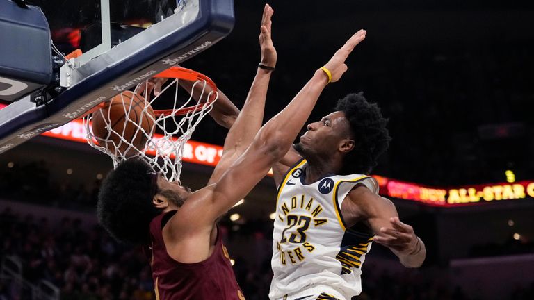 Indiana Pacers forward Aaron Nesmith, right, dunks around the defense of Cleveland Cavaliers center Jarrett Allen during the second half of an NBA basketball game in Indianapolis, Thursday, Dec. 29, 2022. The Pacers won 135-126. (AP Photo/AJ Mast)