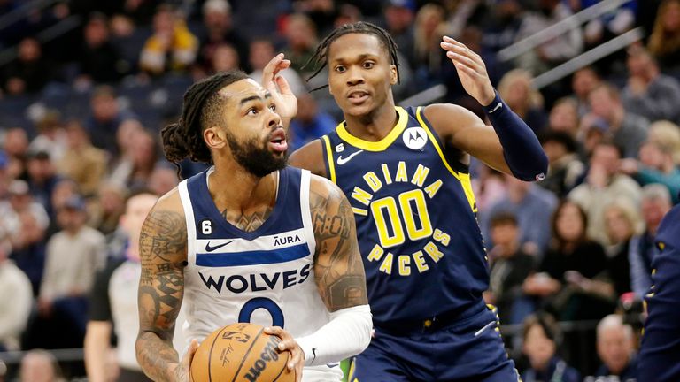 Minnesota Timberwolves guard D&#39;Angelo Russell (0) shoots on Indiana Pacers guard Bennedict Mathurin (00) in the second quarter of an NBA basketball game, Wednesday, Dec. 7, 2022, in Minneapolis. (AP Photo/Andy Clayton-King)


