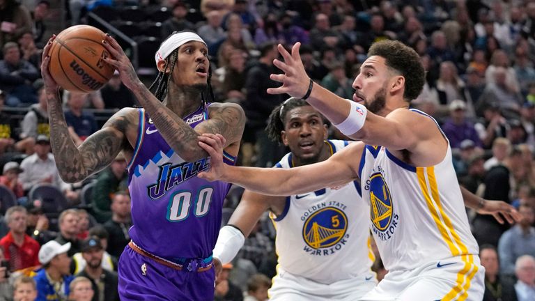 Utah Jazz guard Jordan Clarkson (00) drives as Golden State Warriors&#39; Klay Thompson (11) and Kevon Looney (5) defend during the second half of an NBA basketball game Wednesday, Dec. 7, 2022, in Salt Lake City. (AP Photo/Rick Bowmer)


