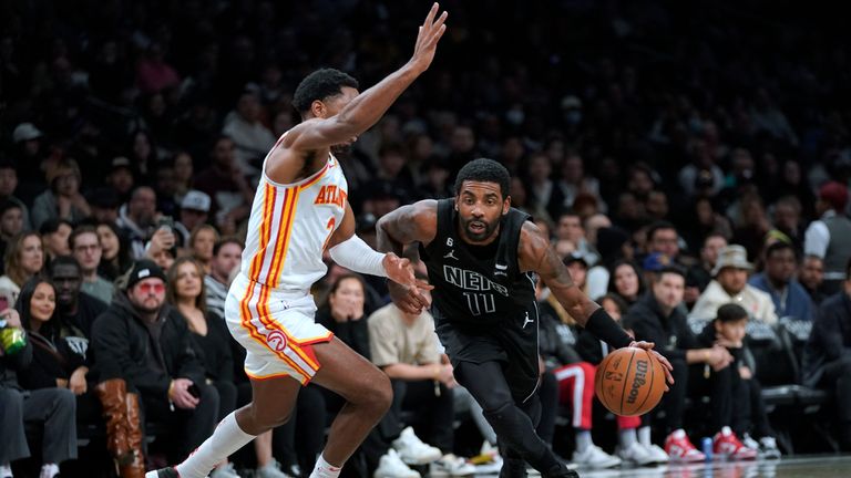 Brooklyn Nets guard Kyrie Irving (11) drives against Atlanta Hawks guard Trent Forrest (2) during the second half of an NBA basketball game Friday, Dec. 9, 2022, in New York. The Nets won 120-116.