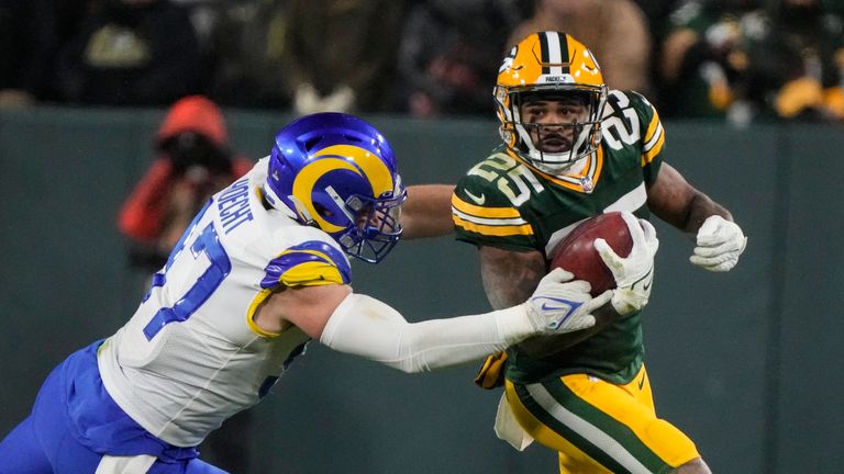 Green Bay Packers&#39; Keisean Nixon (25) is hit by Los Angeles Rams defensive tackle Michael Hoecht (97) as he return a punt in the second half of an NFL football game in Green Bay, Wis. Monday, Dec. 19, 2022.