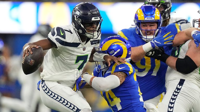 Seattle Seahawks quarterback Geno Smith (7) tries to avoid being tackled by Los Angeles Rams safety Taylor Rapp (24) during the second half of an NFL football game Sunday, Dec. 4, 2022, in Inglewood, Calif. 