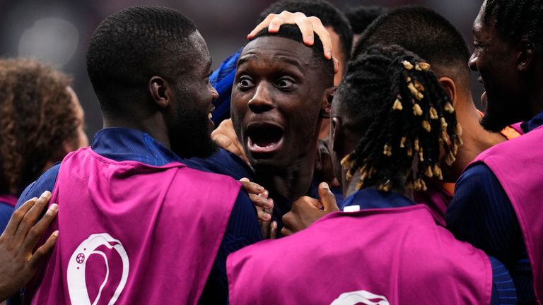 Randal Kolo Muani celebrates with team-mates after doubling France's lead