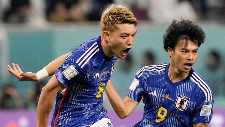 Japan's Ritsu Doan, left, celebrates with teammate Kaoru Mitoma scoring his side's first goal against Spain during a World Cup group E soccer match at the Khalifa International Stadium in Doha, Qatar, Thursday, Dec. 1, 2022. (AP Photo/Eugene Hoshiko)