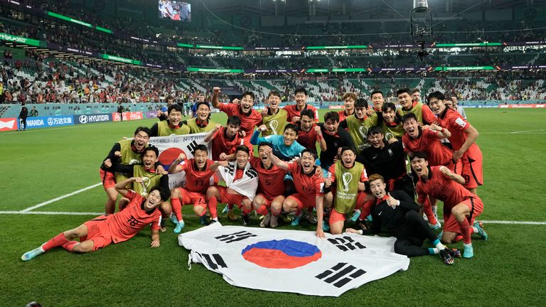 South Korea celebrate at full time after defeating Portugal to progress to the Round of 16 in Qatar