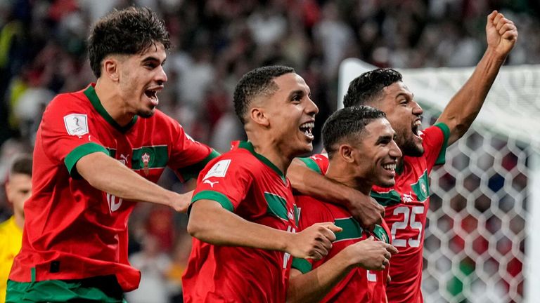 Morocco players celebrate after beating Spain on penalties