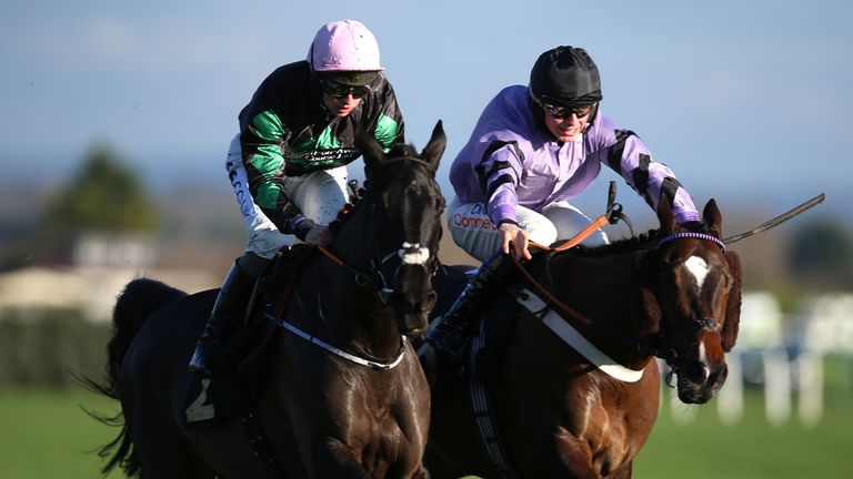 Strong Leader (left) races away from Jaramillo at Aintree
